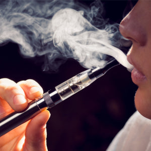 Person smoking a vaporizer producing vapor